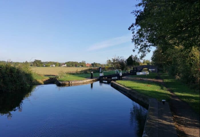 Scenic canal view at Marston Farm Hotel with lush greenery and calm waters.