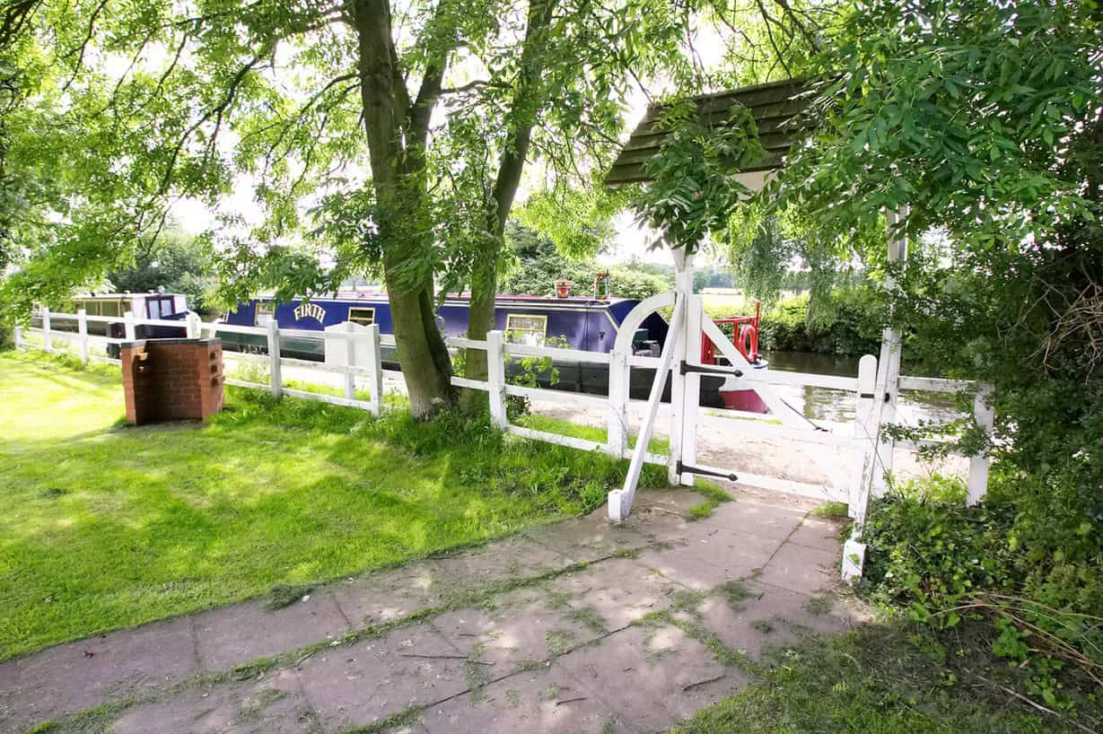 Wedding garden with lush greenery and charming white fence at Marston Farm Hotel.