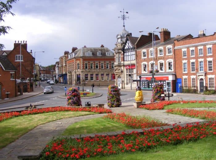 Historic town square with colorful flowers and classic architecture.