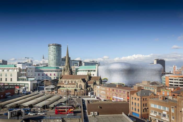 City skyline with modern buildings and historic church spire.